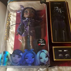 Rainbow High Tiny Imperfection in plastic on top of. Doll Perfect